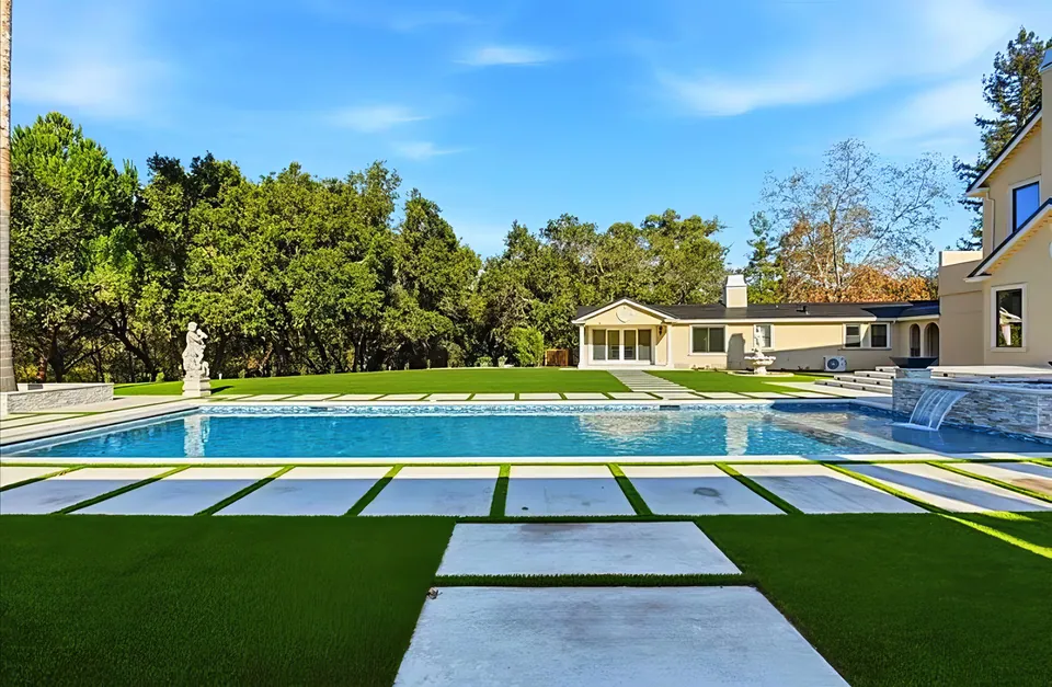 Estate pool: paver walks set in turf beside a long rectangular pool