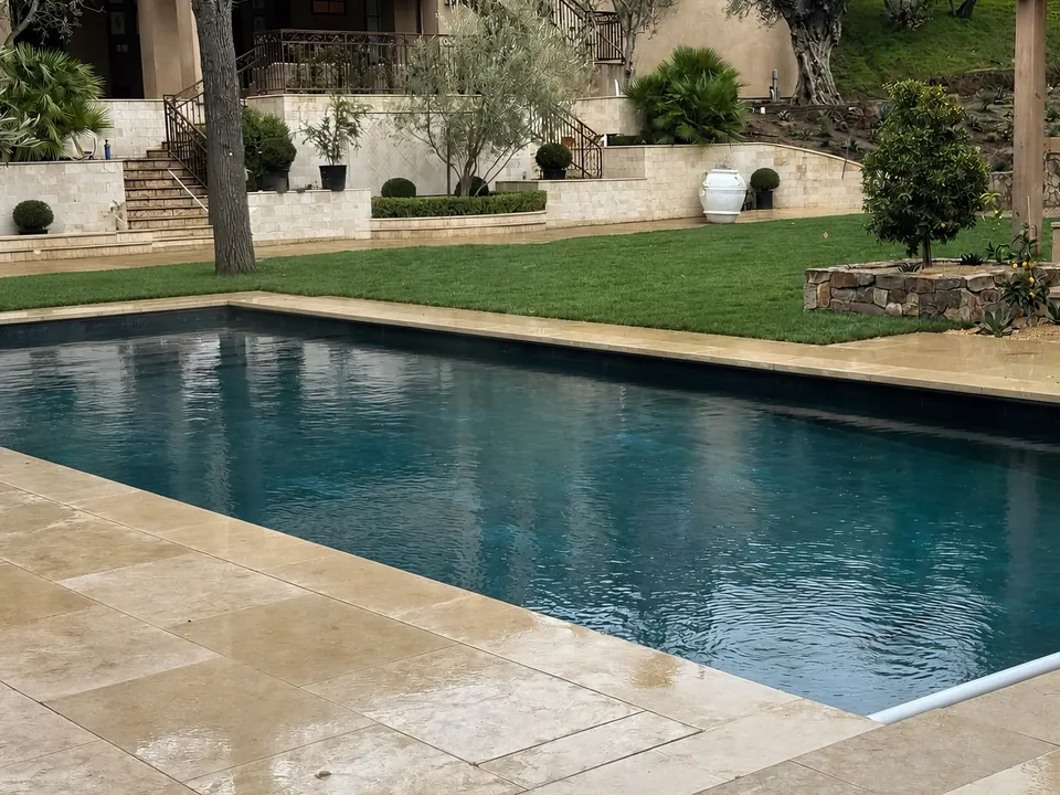Travertine deck: classic rectangular pool with stone coping below terraced gardens