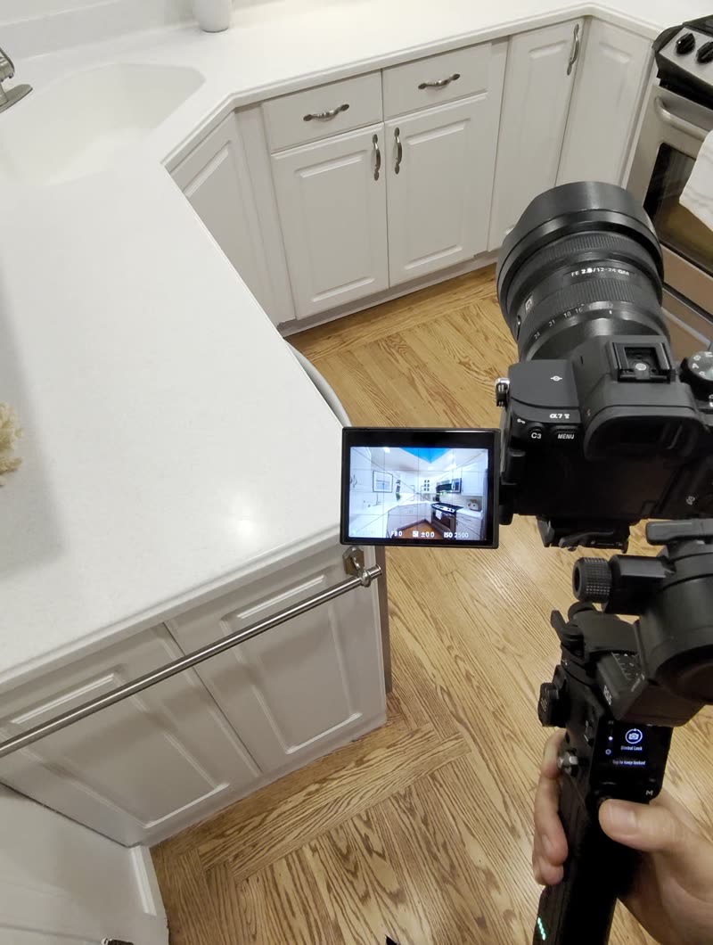 POV clip: camera raised over a kitchen countertop, grid and center marker on the flip screen